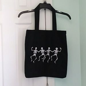 Black canvas tote with dancing skeletons